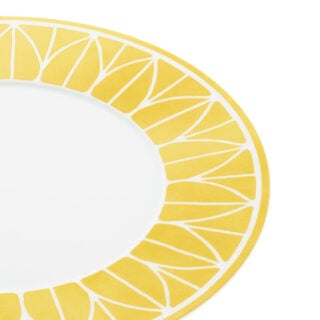 Close-up shot of Christofle Malmaison Riviera Dinner Plate in yellow Limoges porcelain with hand-drawn palmette detailing | Kneen & Co