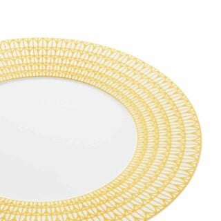 Close-up shot of Christofle Malmaison Riviera Charger Plate in yellow Limoges porcelain with hand-drawn palmette detailing | Kneen & Co