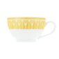 Close-up shot of Christofle Malmaison Riviera Tea Cup and Saucer in yellow Limoges porcelain with hand-drawn palmette detailing | Kneen & Co