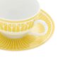 Close-up shot of Christofle Malmaison Riviera Tea Cup and Saucer in yellow Limoges porcelain with hand-drawn palmette detailing | Kneen & Co