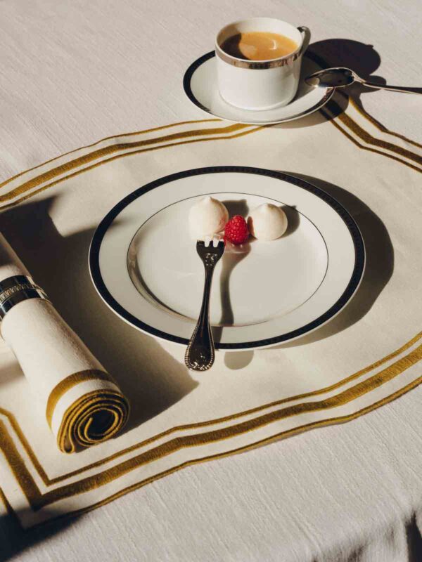 Minimalist dessert setting featuring a Christofle Malmaison porcelain plate and coffee cup | Kneen & Co