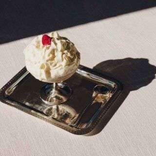 Lifestyle setting featuring a Christofle Malmaison footed dessert bowl in silver plate | Kneen & Co
