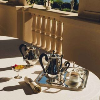 Sun-drenched setting featuring a Christofle Malmaison Silver-Plated Tea and Coffee Service | Kneen & Co