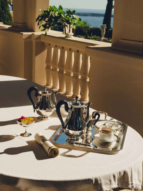 Sun-drenched setting featuring a Christofle Malmaison Silver-Plated Tea and Coffee Service | Kneen & Co
