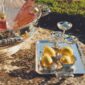 Golden hour garden setting featuring a Christofle Malmaison large silver-plated ice bucket champagne coupes | Kneen & Co