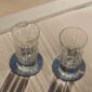 Sunlit casual lifestyle setting featuring Christofle Malmaison crystal tumblers showcasing deep vertical light-refracting cuts | Kneen & Co