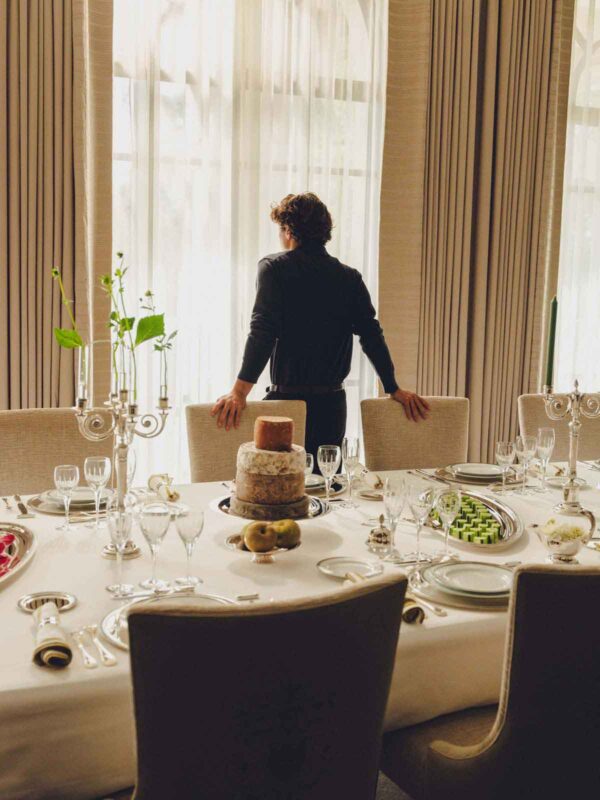 Sophisticated indoor dining setting featuring Christofle Malmaison dinnerware | Kneen & Co