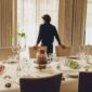 Sophisticated indoor dining setting featuring Christofle Malmaison dinnerware | Kneen & Co