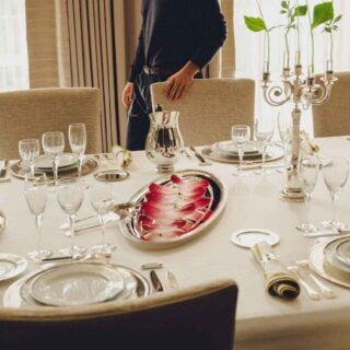 Elegant formal dining room setting featuring a Christofle Malmaison dinnerware | Kneen & Co