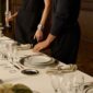 Sophisticated evening dinner party setting featuring Christofle Malmaison porcelain plates highlighting refined platinum borders | Kneen & Co