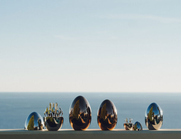 Scenic outdoor setting of the Christofle Mood Flatware Set in an egg-shaped storage | Kneen & Co
