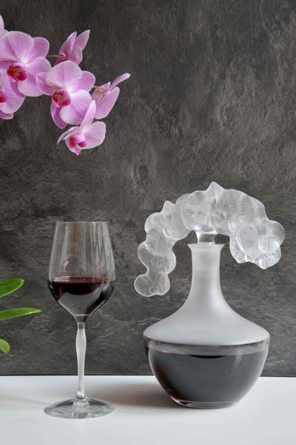 LALIQUE-Stemware-Decanter-10709400-ORCHIDEE-CLEAR-Lifestyle-Image-5-1200w-100KB Lalique Lalique Orchidée Decanter and wine glass set on table | Kneen & Co