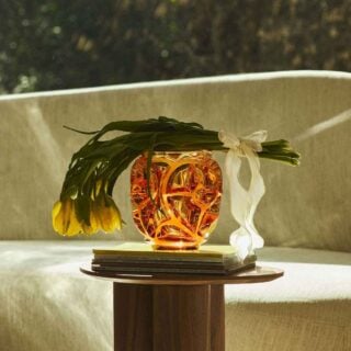 Lalique Tourbillons Vase Amber set on garden table | Kneen & Co