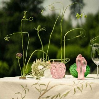 Lalique Tourbillons Small Vase Pink Luster set on garden table | Kneen & Co