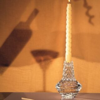 Saint-Louis Crystal Folia Large Candlestick with lit tapered candle on tabletop | Kneen & Co