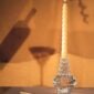 Saint-Louis Crystal Folia Large Candlestick with lit tapered candle on tabletop | Kneen & Co