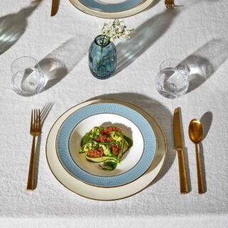 Wedgwood-Helia-Lifestyle-6-2023-1200w-100KB Modern dinner setting with Wedgwood Helia Dinnerware in fine bone china with 22-carat gold trim and blue pinstripe borders | Kneen & Co