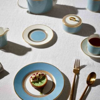 Wedgwood-Helia-Lifestyle-9-2023-1200w-100KB Modern dinner setting with Wedgwood Helia Dinnerware in fine bone china with 22-carat gold trim and blue pinstripe borders | Kneen & Co