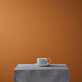 Minimalist gallery display on a stone plinth with Wedgwood Helia Teacup and Saucer in fine bone china with gold banding | Kneen & Co