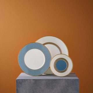 Wedgwood-Helia-Styled-plate-group-2023-1200w-100KB Artistic gallery display on a stone plinth with Wedgwood Helia Plates in fine bone china with gold detailing | Kneen & Co