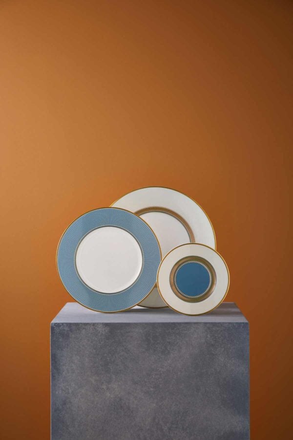 Artistic gallery display on a stone plinth with Wedgwood Helia Plates in fine bone china with gold detailing | Kneen & Co