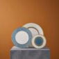 Artistic gallery display on a stone plinth with Wedgwood Helia Plates in fine bone china with gold detailing | Kneen & Co