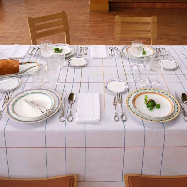 Table setting with the Hermès en Contrepoint Dinnerware, showing kaolin white porcelain pieces with hand-drawn geometric watercolor borders | Kneen & Co