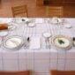 Table setting with the Hermès en Contrepoint Dinnerware, showing kaolin white porcelain pieces with hand-drawn geometric watercolor borders | Kneen & Co