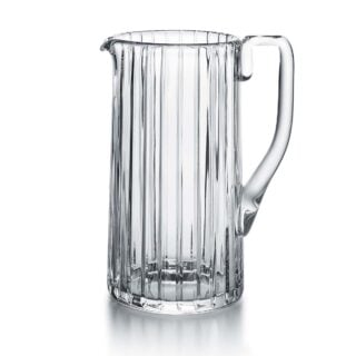 Baccarat Harmonie Pitcher handcrafted in clear French crystal with signature vertical cuts, a curved handle, and elegant pouring spout | Kneen & Co