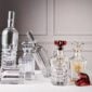 Baccarat crystal decanters from the Harcourt 1841, Harmonie, and Louxor collections displayed together on a refined tabletop, showcasing handcrafted French crystal, architectural silhouettes, and signature cut patterns. | Kneen & Co.