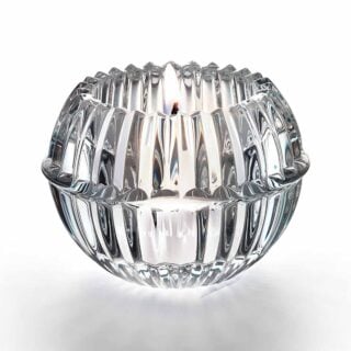 Baccarat Mille Nuits Votive handcrafted in clear French crystal with a beveled petal-inspired silhouette that enhances the glow of candlelight | Kneen & Co