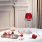 Baccarat Harcourt 1841 Coupes, Set of 2 with signature red crystal accents displayed alongside Baccarat décor on an elegantly styled table | Kneen & Co
