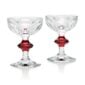 Baccarat Harcourt 1841 Coupes, Set of 2 in clear French crystal with a passion red stem accent, hexagonal foot, and six flat-cut facets | Kneen & Co