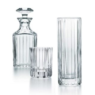 Baccarat Harmonie crystal barware collection featuring tumblers, highballs, whiskey glasses, decanters, and pitchers with signature vertical fluting | Kneen & Co