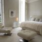 Elegant luxury bedroom setting with Lalique Champs-Elysées Wall Sconce in clear crystal and a chrome finish mounted on the wall | Kneen & Co