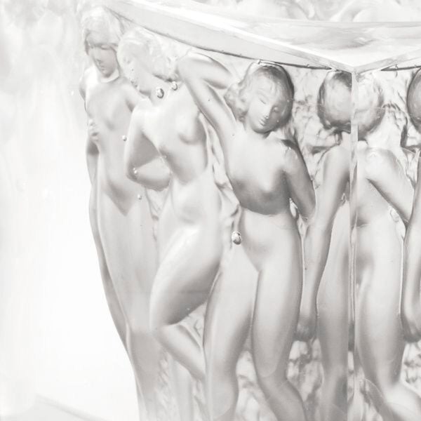 LALIQUE-10066000-revelation-bacchantes-vase-2-jpg-1200w-100KB Close-up studio shot of the Lalique Révélation Bacchantes Vase in clear crystal, showcasing the intricate satin-finish | Kneen & Co