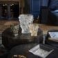 Cozy, upscale living room featuring the Lalique Bacchantes Small Vase in clear, gold luster, and grey satin-finished crystal | Kneen & Co