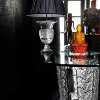 Moody interior setting with a Lalique Versailles Table Lamp in clear satin-finished crystal and a black pleated fabric shade | Kneen & Co