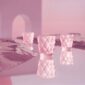Minimalist monochrome pink set with architectural arches and reflective surfaces featuring the Lalique Anemones Votive in pink crystal, detailed with an elegant all-over textured floral pattern | Kneen & Co