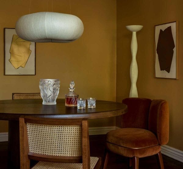Sophisticated warm-toned dining room featuring the Lalique Bacchantes Vase in clear and frosted satin-finished crystal | Kneen & Co