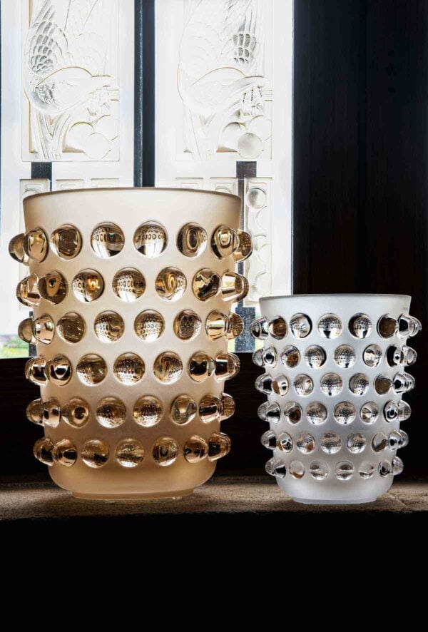 LALIQUE-Mossi-Vase-Nmbr10411600-1200w-100KB Brightly lit interior setting featuring the Lalique Mossi XXL Vase in clear and frosted crystal with a gold luster finish, side-by-side with a smaller classic clear Mossi vase | Kneen & Co
