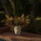 Lush outdoor poolside setting featuring the Lalique Champs-Élysées Vase in clear and frosted crystal | Kneen & Co