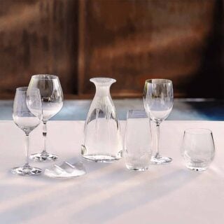Lalique Owl Decanter and Owl Tumblers in clear crystal displayed with whiskey on a dark wood table | Kneen & Co