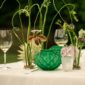 Al fresco dining table set with white wine glasses and dynamic floral stems featuring the Lalique Languedoc Small Vase in green satin-finished crystal | Kneen & Co