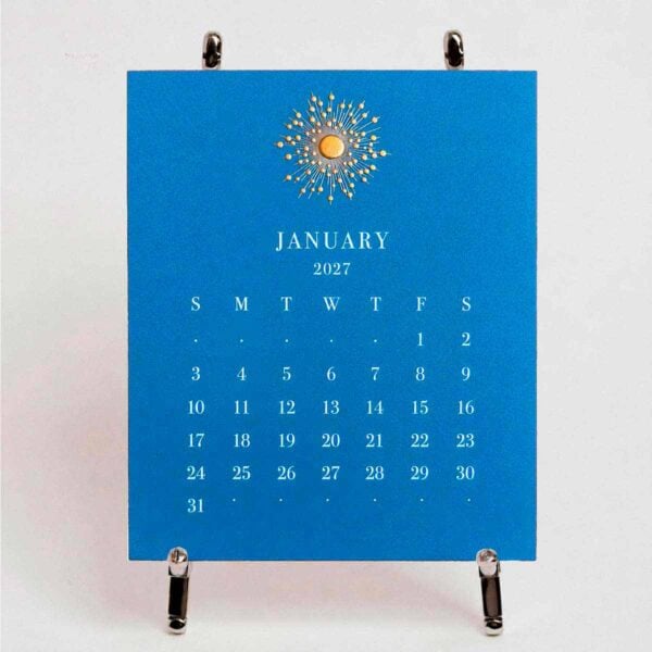The Printery 2027 Calendar - Cornflower, white text with starburst engraved in gold | Kneen & Co