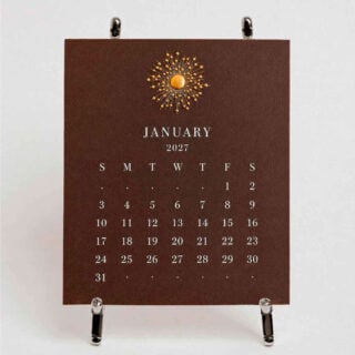The Printery 2027 Calendar - Espresso, white text with starburst engraved in gold | Kneen & Co