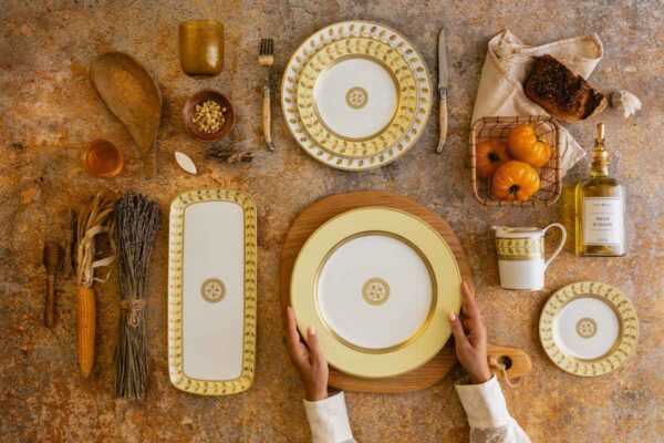 Bernardaud Constance Jaune Dinnerware set on table | Kneen & Co